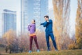 Sport couple doing warm-up exercise before starting a run