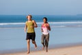 Sport couple jogging on the beach Royalty Free Stock Photo