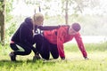 Sport couple outdoors with sling trainer Royalty Free Stock Photo