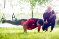 Sport couple outdoors with sling trainer Royalty Free Stock Photo