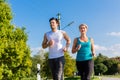 Sport couple running and jogging on rural street