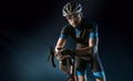 Sport. Cyclist carry a bike on black background.