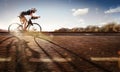 Sport. The cyclist rides on his bike at sunset.