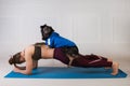 Sport with a dog. Attractive girl working out on the blue fitness mat with her dog. Athletic woman doing exercise Royalty Free Stock Photo