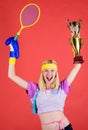 Sport equipment store. Sport shop assortment. Girl cheerful successful modern woman hold golden goblet of sport champion Royalty Free Stock Photo