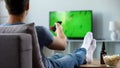 Sport fan watching recording of missed soccer match, modern smart tv technology