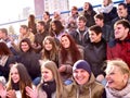 Sport fans clapping and singing on tribunes. Winter weather. Royalty Free Stock Photo