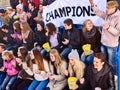 Sport fans holding champion banner on tribunes. Winter weather. Royalty Free Stock Photo