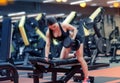 Young woman flexing muscles with dumbbell in gym Royalty Free Stock Photo