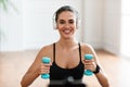 Happy Sporty Woman Exercising With Two Dumbbells And Posing Royalty Free Stock Photo