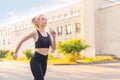 Sport and Fitness. Fit Woman Running City Street Summer Sunny Morning Caucasian Athletic Female Jogging Outdoor Cardio Training Royalty Free Stock Photo