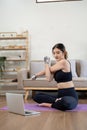 sport, fitness and healthy lifestyle concept - Portrait happy smiling young asian woman with laptop computer stretching Royalty Free Stock Photo