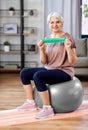 senior woman exercising with elastic band at home Royalty Free Stock Photo