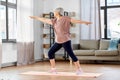 happy senior woman exercising on yoga mat at home Royalty Free Stock Photo