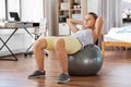 teenage girl training on exercise ball at home Royalty Free Stock Photo