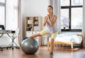 teenage girl training on exercise ball at home Royalty Free Stock Photo