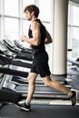 Sport, fitness, lifestyle, technology and people concept - smiling man exercising on treadmill in gym Royalty Free Stock Photo