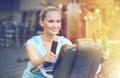 Smiling woman exercising on exercise bike in gym Royalty Free Stock Photo