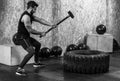 Sport Fitness Man Hitting Wheel Tire With Hammer Sledge Crossfit Training, Young Healthy Guy