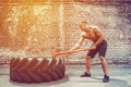 Sport Fitness Man Hitting Wheel Tire With Hammer Sledge Crossfit Training. Royalty Free Stock Photo