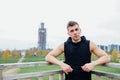 Sport fitness man posing against the backdrop of the city. Male athlete outside fall park. Fit model. Royalty Free Stock Photo