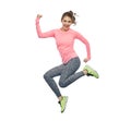 Happy smiling sporty young woman jumping in air Royalty Free Stock Photo
