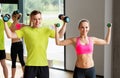 Couple with dumbbells exercising in gym Royalty Free Stock Photo