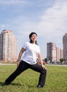 Smiling senior woman warming up stretching outdoors in the park Royalty Free Stock Photo