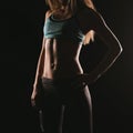 Sport fitness woman training on dark background. Beautiful body Royalty Free Stock Photo