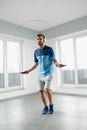 Sport Fitness Workout. Healthy Man Skipping Jump Rope Indoors. Royalty Free Stock Photo