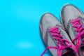 Sport flat lay pink shoes on blue background with copyspace for your text. Concept healthy lifestyle and diet Royalty Free Stock Photo