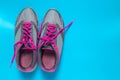 Sport flat lay pink shoes on blue background with copyspace for your text. Concept healthy lifestyle and diet Royalty Free Stock Photo