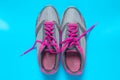 Sport flat lay pink shoes on blue background with copyspace for your text. Concept healthy lifestyle and diet Royalty Free Stock Photo