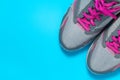 Sport flat lay pink shoes on blue background with copyspace for your text. Concept healthy lifestyle and diet. Royalty Free Stock Photo