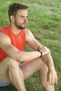 Sport gadget concept. Athlete with fitness tracker or pedometer. Man athlete on calm face relaxing, nature background