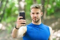 Sport gadget concept. Athlete mobile phone set up playlist before runnig. Man athlete busy face setting up smartphone Royalty Free Stock Photo