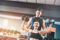 Sport girl doing weight exercises working with heavy dumbbells