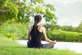 Sport girl meditating in nature green park at the sunrise Royalty Free Stock Photo