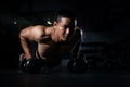 Sport. Handsome man doing push ups exercise with one hand in fitness gym, Sport. Young athletic man doing push-ups. Muscular and s