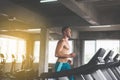Sport handsome man running on treadmills doing cardio training,Cross fit body and muscular in the gym,Toned image