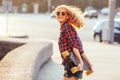 Sport happy girl posing in summer with skateboard. Stylish lucky hipster woman with colorful longboard in sunset in