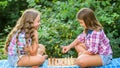 Sport and hobby concept. Little girls play chess. Sisters playing chess. Cognitive development. Intellectual game. Make