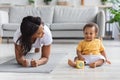 Sport At Home. Young Black Mom Making Plank Exercise With Little Baby Royalty Free Stock Photo