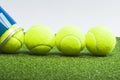 Sport Ideas. Variety of Tennis balls on green artificial grass surface Royalty Free Stock Photo