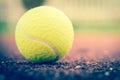 Sport Item concept : Tennis balls at red court in summer day. Tennis is racket sport that can be played individually against