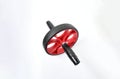 Sport item object, balck and red ab roller wheel on white background with space for text. Essential fitness tool. Home gym