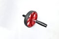 Sport item object, balck and red ab roller wheel on white background with space for text. Essential fitness tool. Home gym