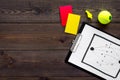 Sport judging concept. Tennis referee. Tactic plan for game, tennis ball, red and yellow cards, whistle on wooden