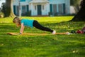 Sport kids. Child is pushing up on the green grass. Boy doing push-ups in the yard. Kid pushing up. Royalty Free Stock Photo