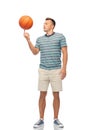 Young man spinning ball on finger Royalty Free Stock Photo